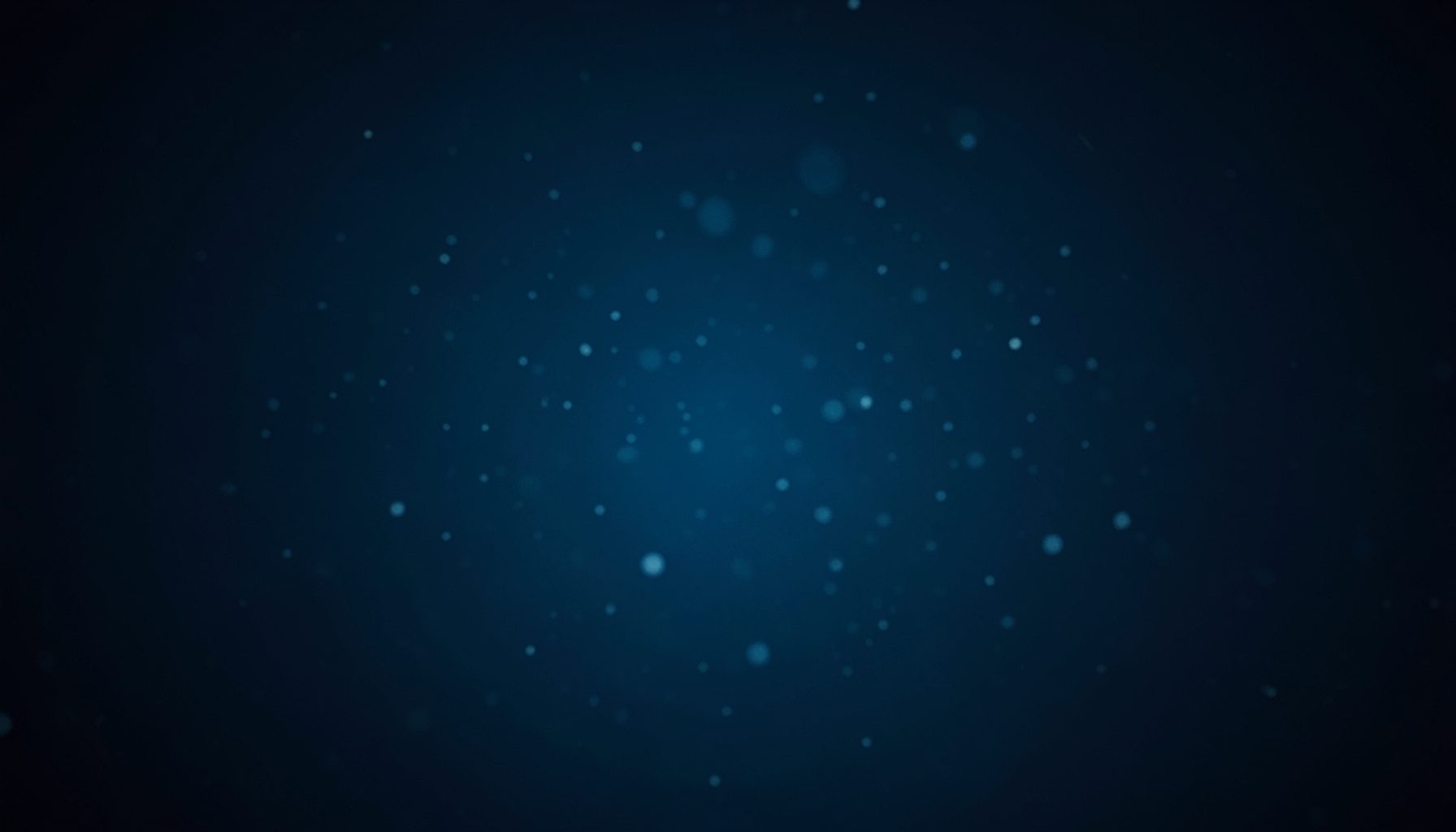 Abstract dark blue background with soft glowing bokeh light particles, calm and atmospheric mood